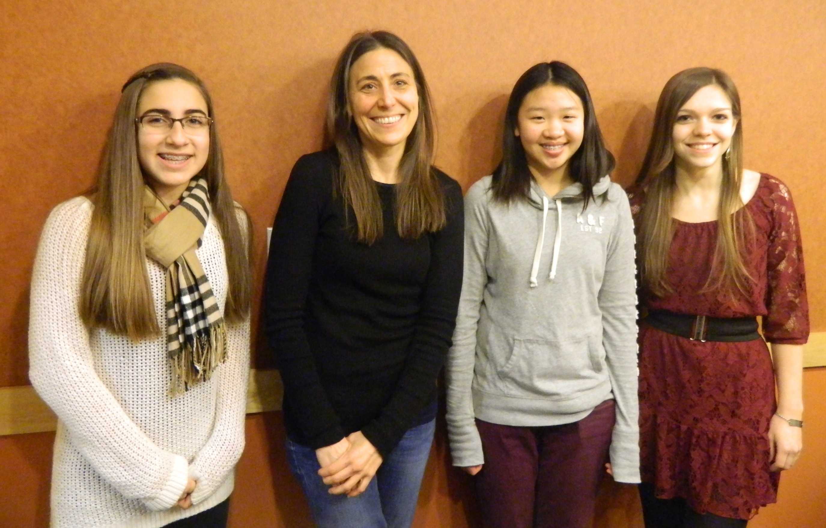 Rebecca Stead (second from left) poses with reporters from the Watertown public school newspapers during the author's visit to Lesley University in Cambridge, Mass., on Jan. 8, 2014.