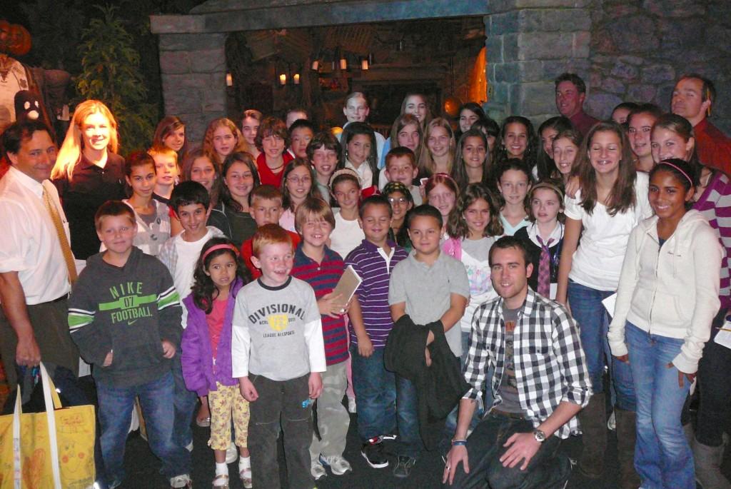 More than 50 representatives of scholastic journalism in the Watertown schools surround actor Matthew Lewis (front row in black-and-white shirt), who plays Neville Longbottom in the Harry Potter films, at a Museum of Science press preview Oct. 22, 2009. 