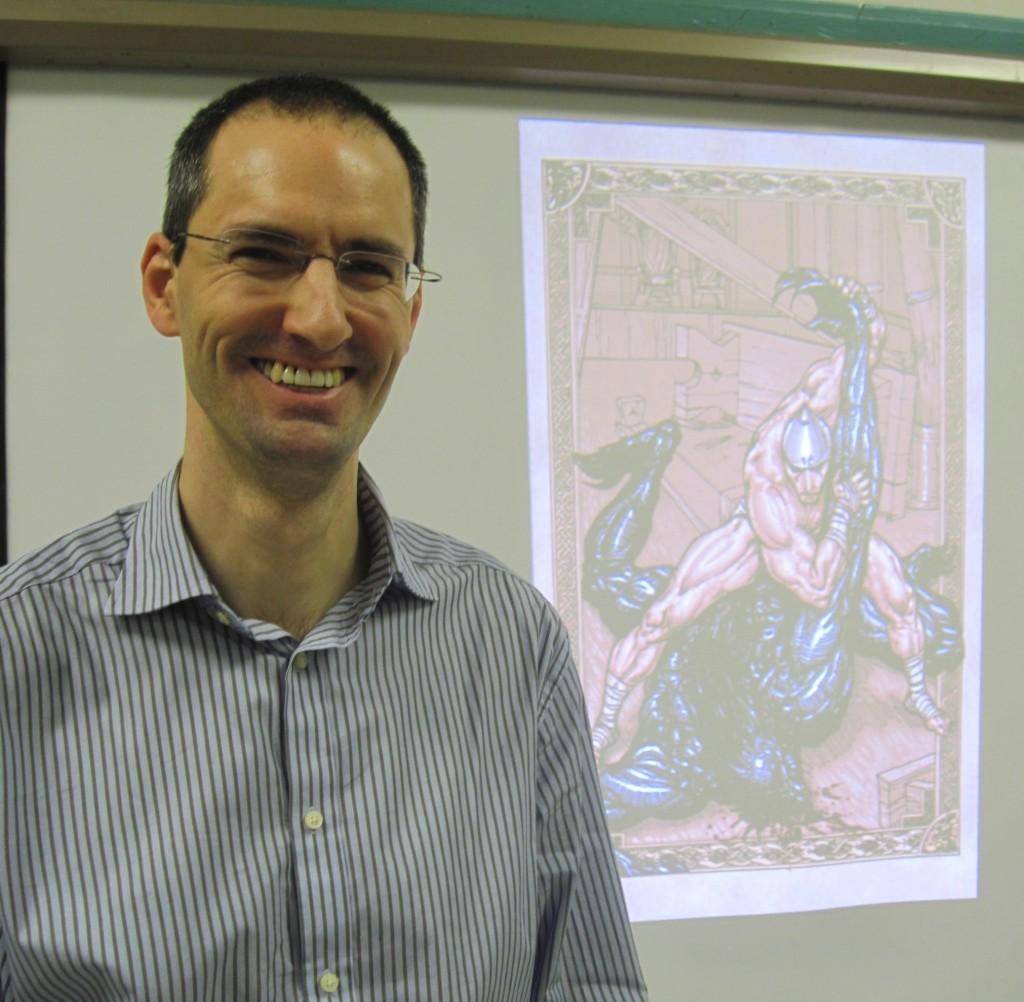 Watertown author/illustrator Gareth Hinds stands before one of his artistic creations.