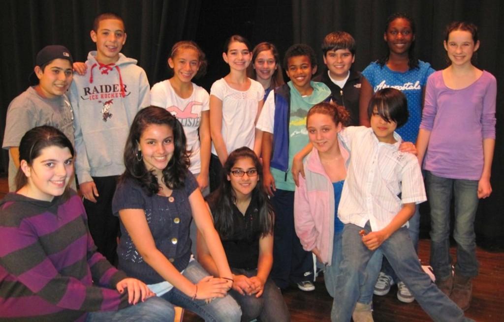 The leads for High School Musical Junior gather on the Watertown Middle School auditorium stage, four months before their first performance.
