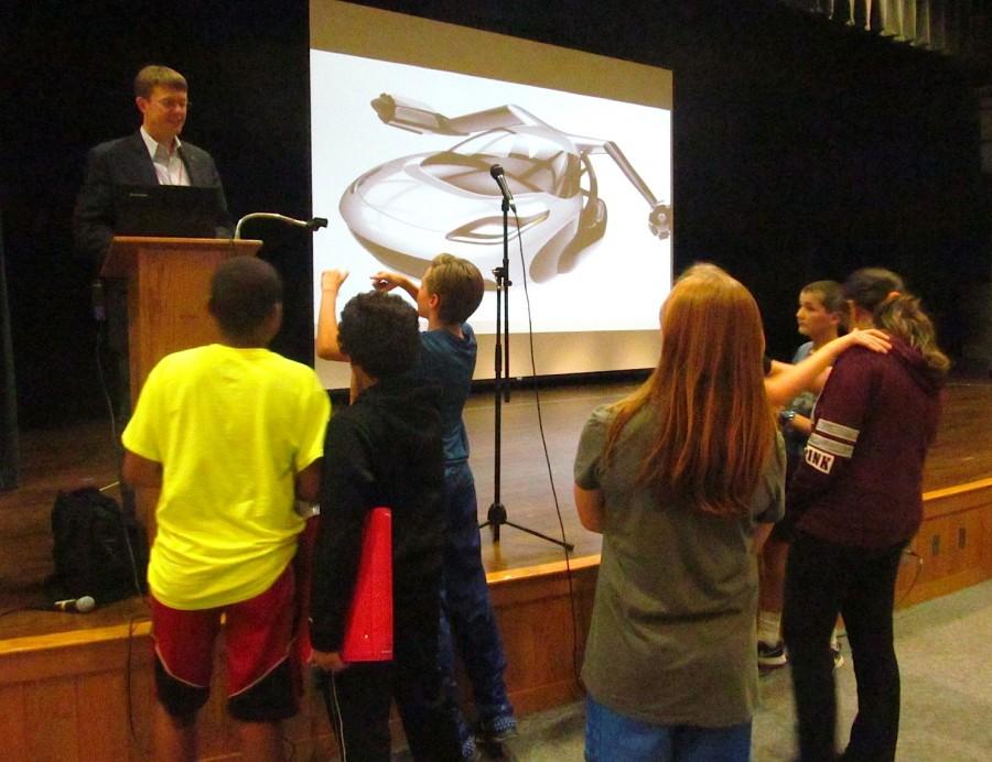 Carl Dietrich of Terrafugia talks flying cars with interested Watertown Middle School students after his presentation on Oct. 7, 2015.