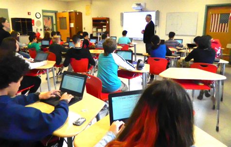 Dr. John Brackett (standing), the Watertown Public Schools interim superintendent, speaks with Watertown Splash reporters in the newsroom at Watertown Middle School on Nov. 16, 2016. 