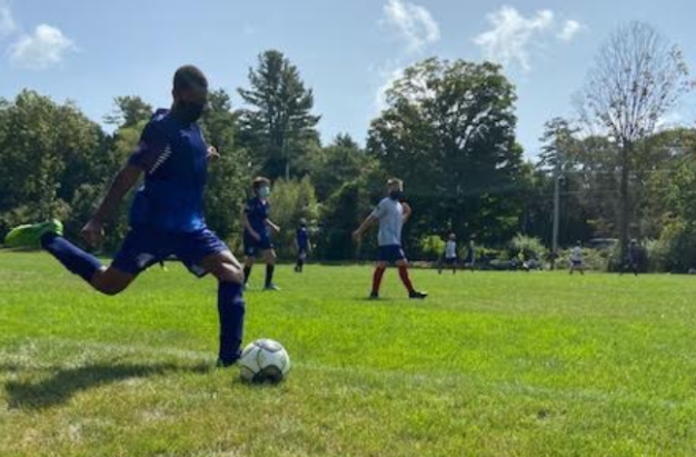 Zerihun Flessas takes a kick-in -- instead of a throw-in -- one of the new rules in play for youth soccer teams this fall. 