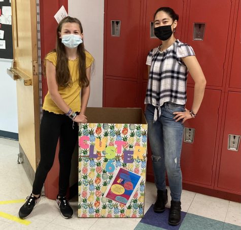 Jojo Jane-Leonardis (left) and Sylvia Sakata stand next one of the collection boxes for the Watertown Middle School clothing drive, which is going on through May 20, 2021.